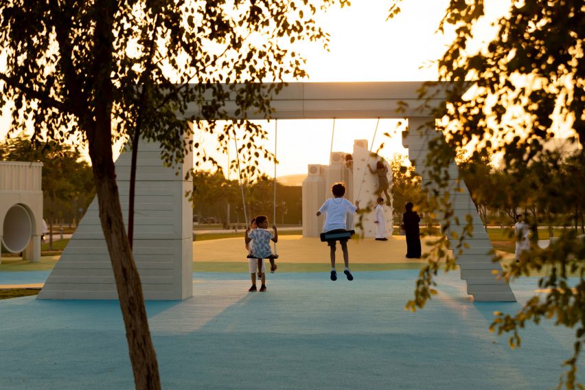 Children playing on a swing
