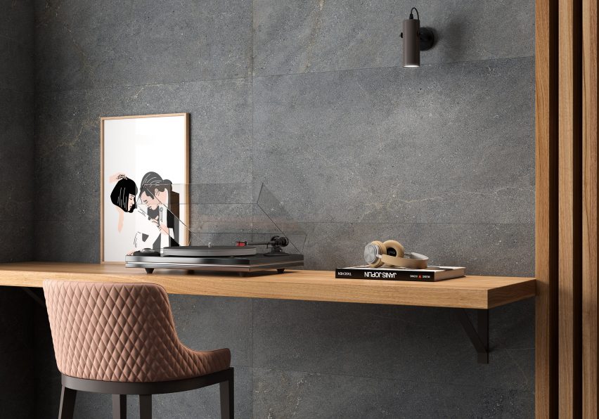 Image of dark grey Fiction tiles covering the walls behind a desk