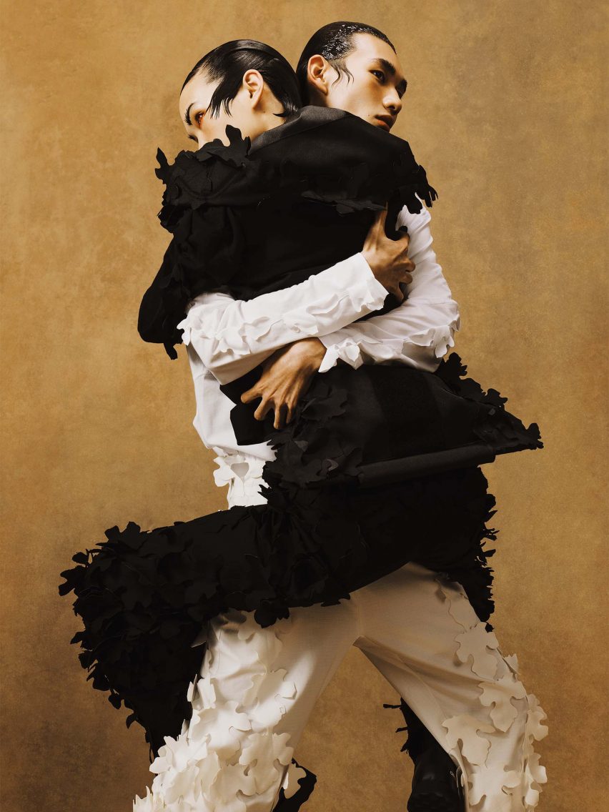 Models wearing white and black outfits with leaf-shaped appliques