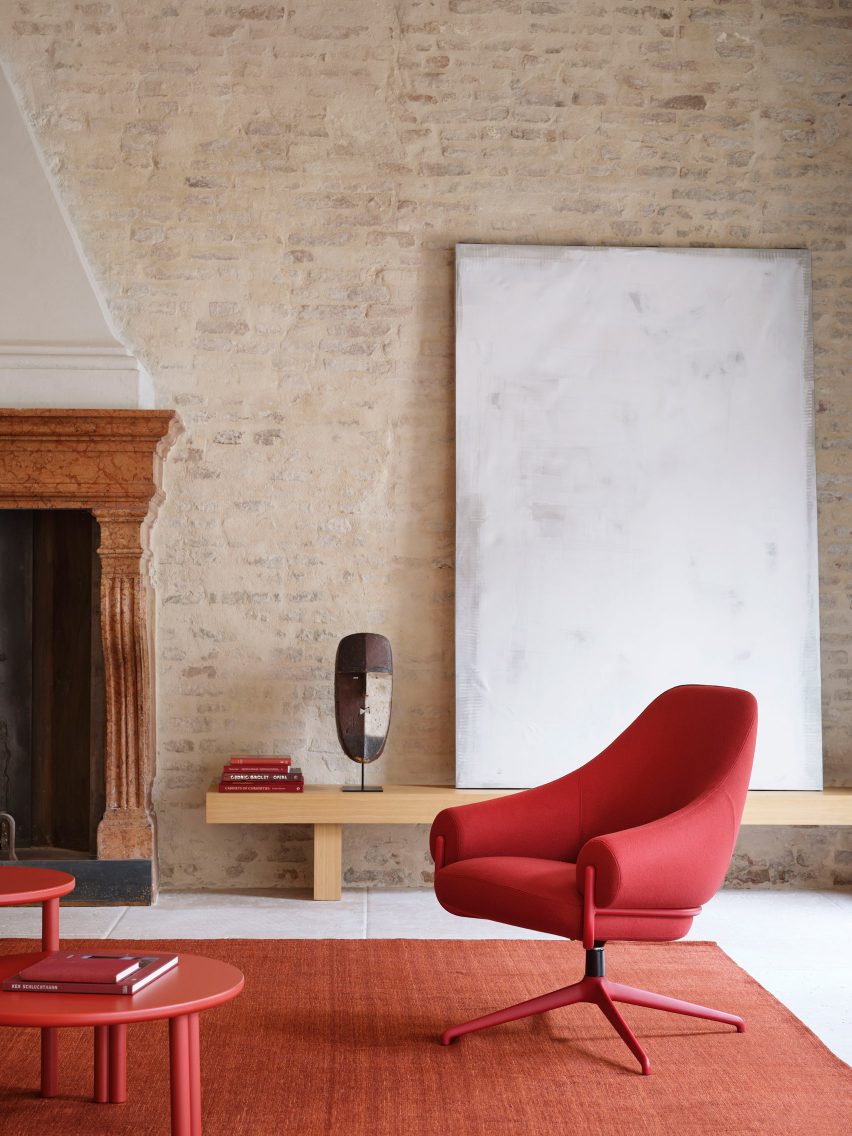 Red chair in minimal interior with fireplace