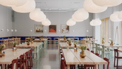 Interior with wooden tables and red chairs