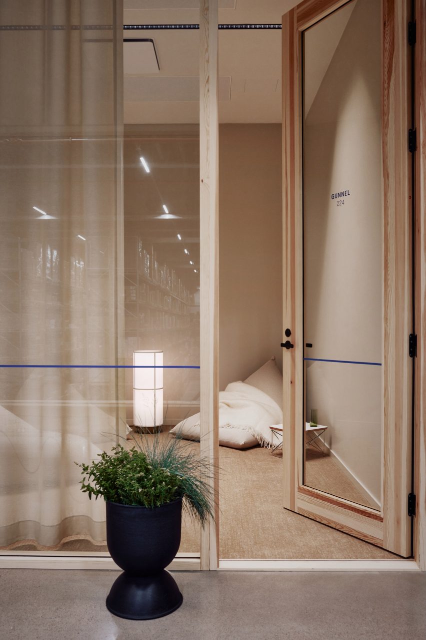 Photo of a timber-framed glass office door with warm light and a beige beanbag with throw rug in one corner