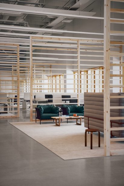 Photo of an open office area with slatted pale wood room dividers and soft furnishings in neutral colours and turquoise