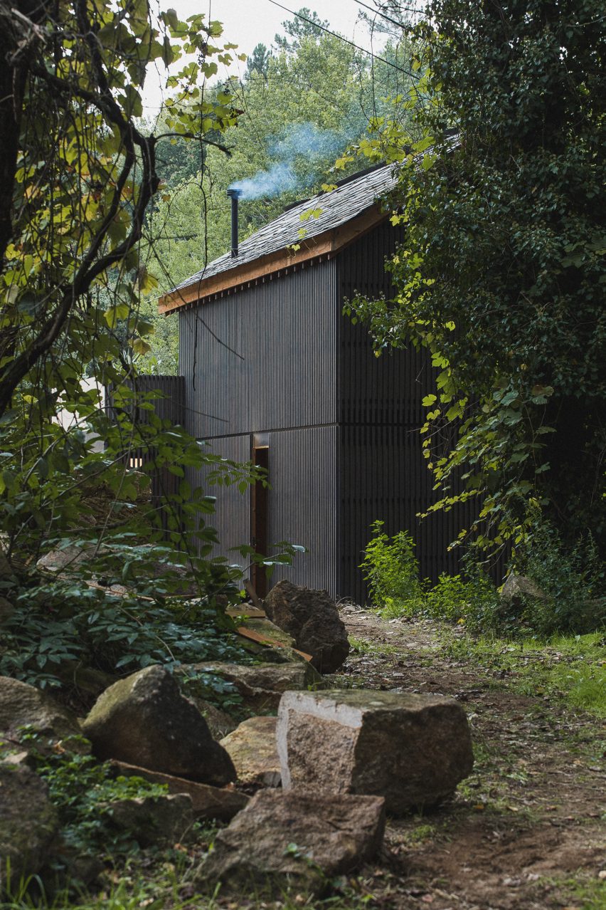 Looking through trees at exterior of Granary House guesthouse by MIMA Housing