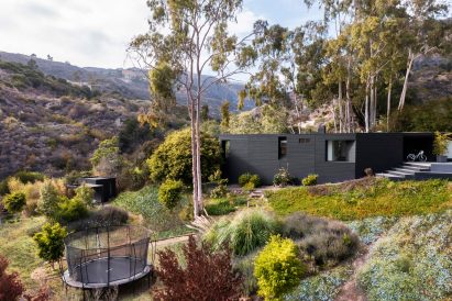 A two storey house nestled in a hillside