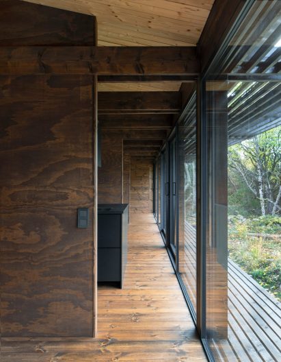 Wood-lined interior of Swedish cabin by HelgessonGonzaga