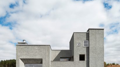 Grey pebble dash house with glazed double doors and large window