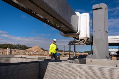 3D printed home in construction with worker
