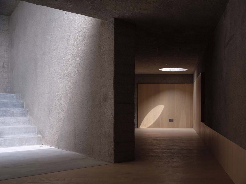 A staircase in a concrete building with light wells