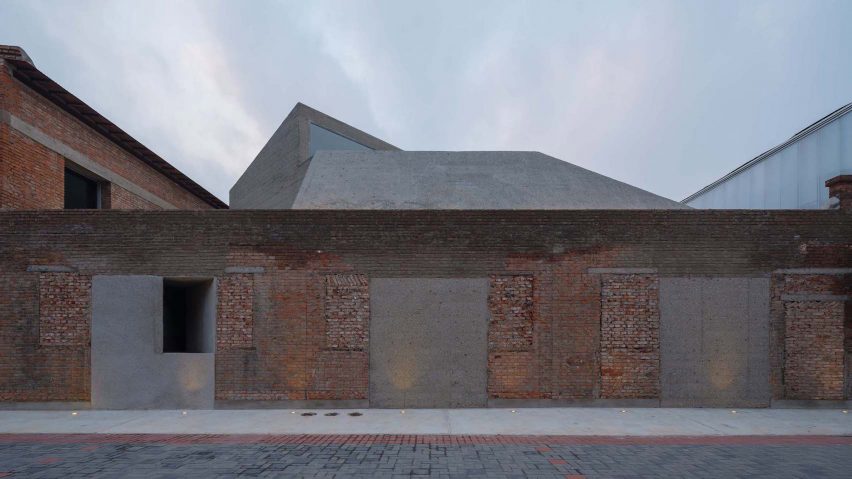 Concrete-and-brick building with jagged roof