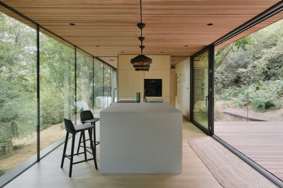 Interior of wooden cabin with white kitchen island