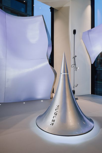 Image of a drop-shaped sculpture surrounded by pale blue walls