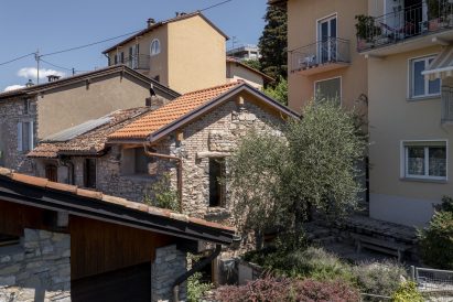 Olive tree in front of facade of Swiss micro home by Enrico Sassi