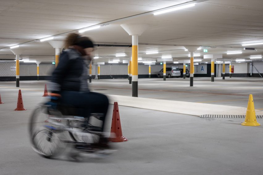A man in a wheelchair in a car park