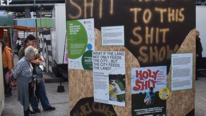 An outdoor installation with a wooden poster board