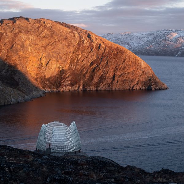 Qaammat by Konstantin Arkitekter on a rocky landscape overlooking a lake