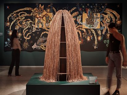 Visitors viewing surrealist artwork displayed in the exhibition