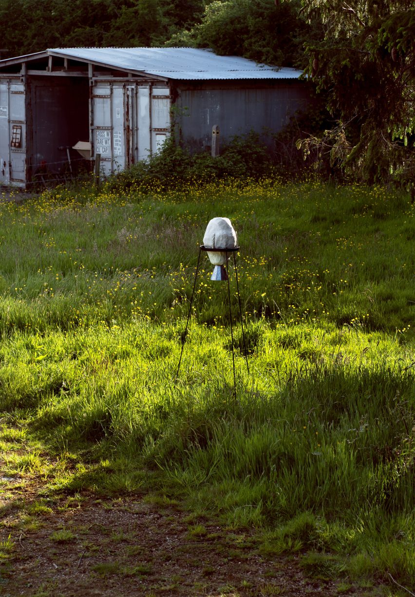Living with Wildfire mycoremediation pod by Suzie McMurtry on metal stilts in a meadow