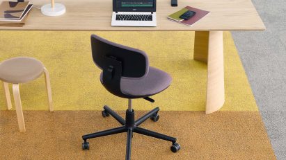 Yellow, orange and grey carget with a desk and office chair by Tarkett