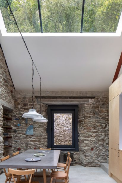 Open-plan kitchen with stone walls