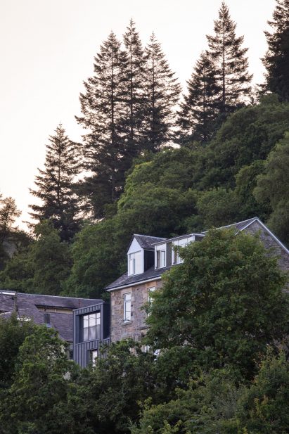Exterior image of The Den emerging from trees