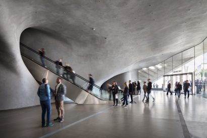 Visitors using the escalator from the lobby leading up to the cavernous vault