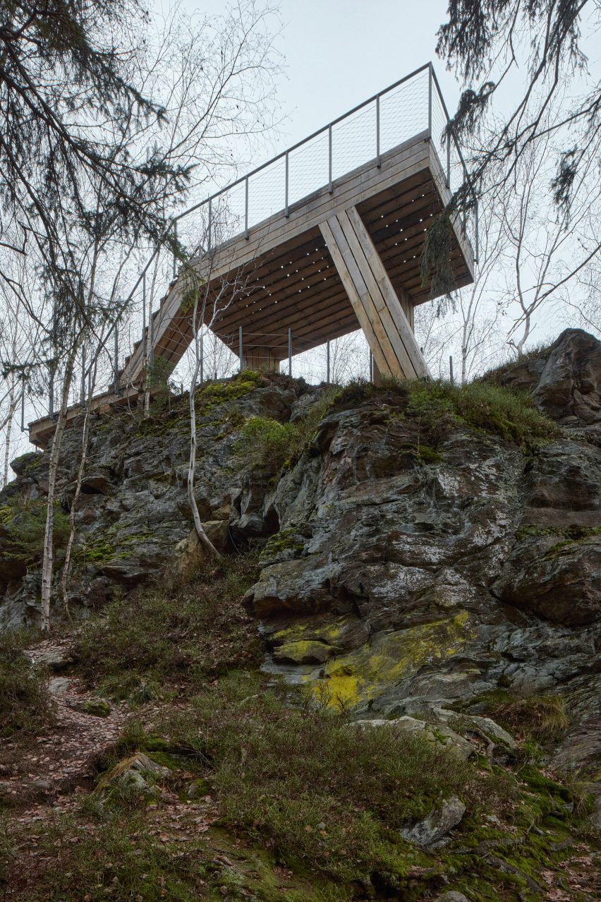 A wood-and-steel lookout post in a forest
