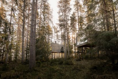 Pair of wooden suites at Trakt Forest Hotel