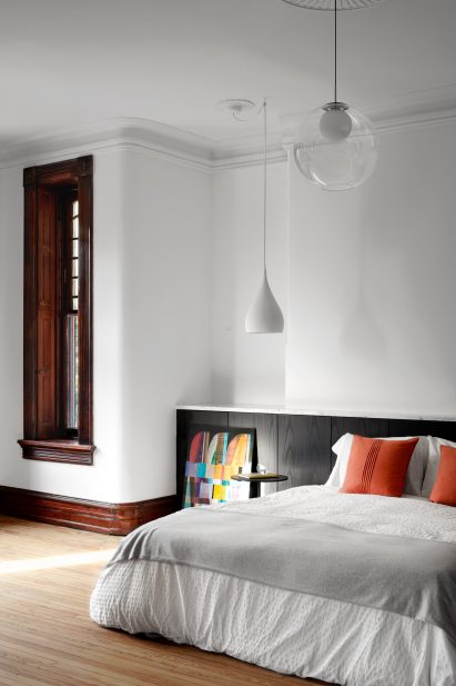 Bedroom with white walls and minimal light fixtures