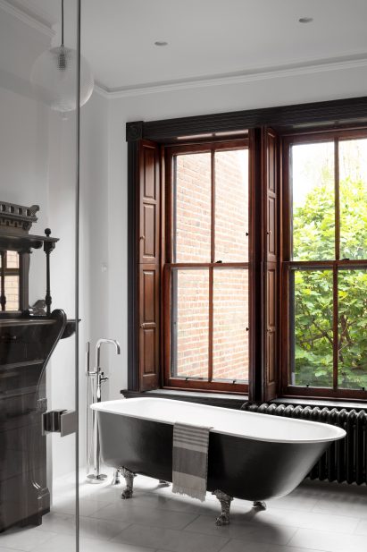 Bathroom with freestanding tub in front of a large window