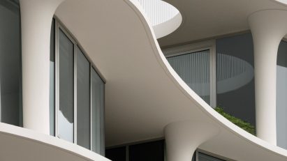 Curved balconies and floorplates of glazed apartment building