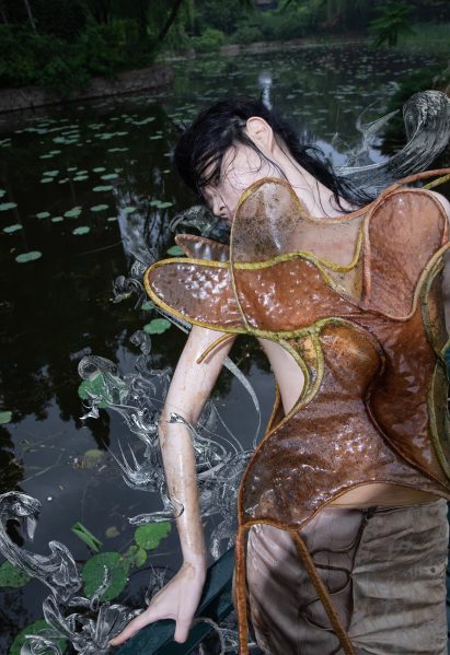 A model in a forest wearing a corset
