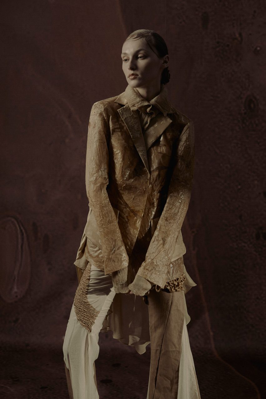 A female model wearing a beige trouser suit