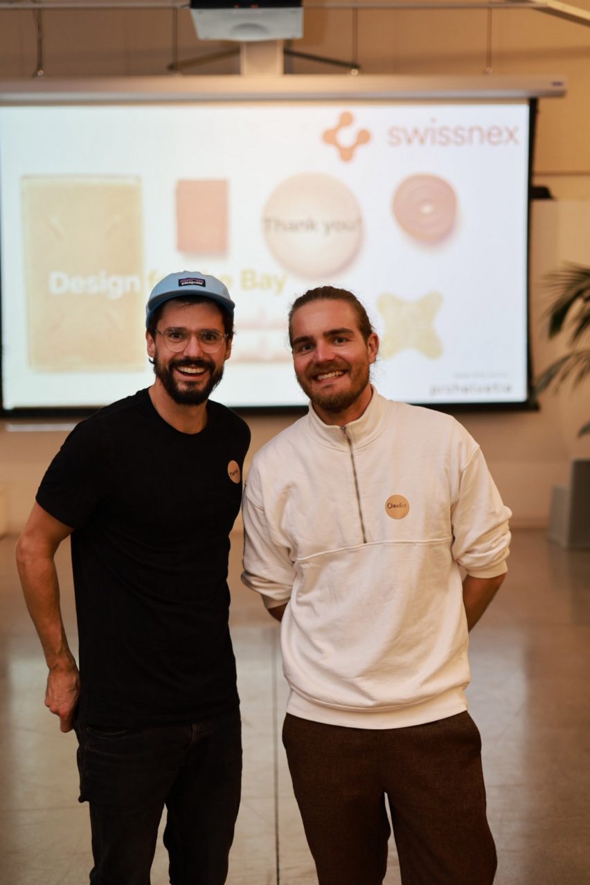 Two people in front of projected image