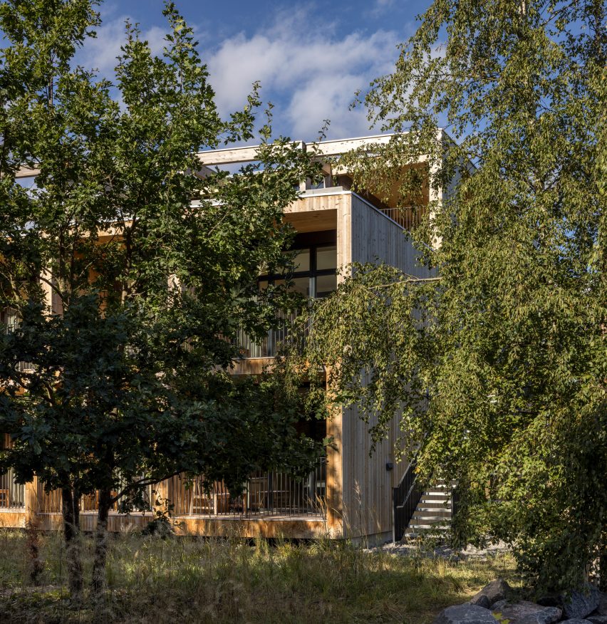 View through trees of Green Solution House 2.0 by 3XN