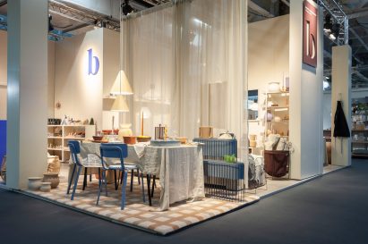 A photo of a showroom with a table and chairs