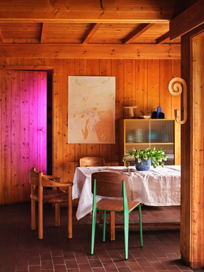 Photo of wooden chairs at a table in a wooden panelled room