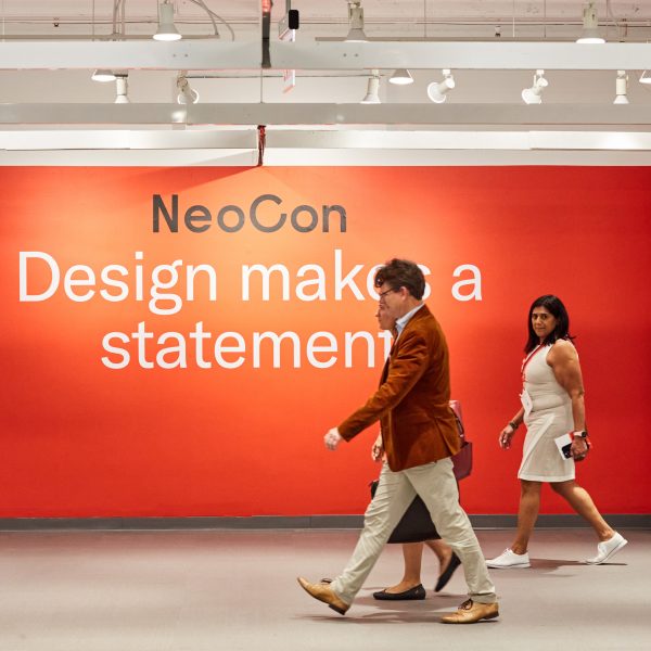 Photo of the NeoCon logo on a red wall
