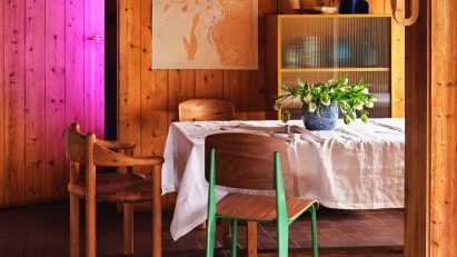 Photo of wooden chairs at a table in a wooden panelled room