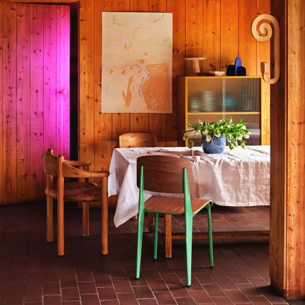 Photo of wooden chairs at a table in a wooden panelled room