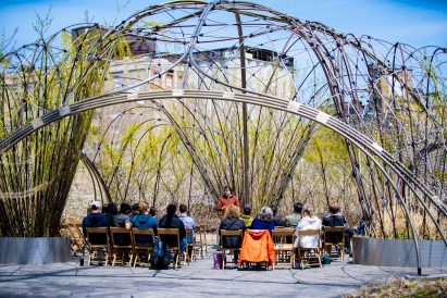 Image of a Trellis with people sat under it