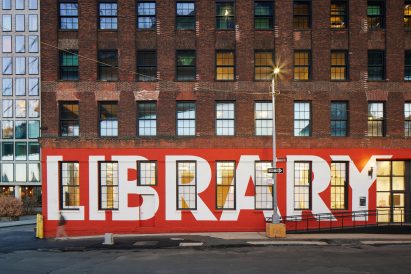 Adams Street Library facade with library painted in white letters on red background