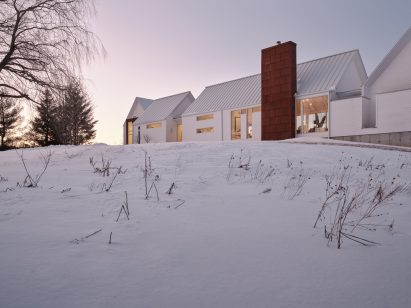 White home with weathering steel chimney