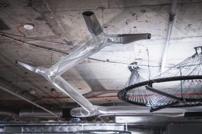 Photo of translucent plastic tubes branching underneath a concrete slab ceiling