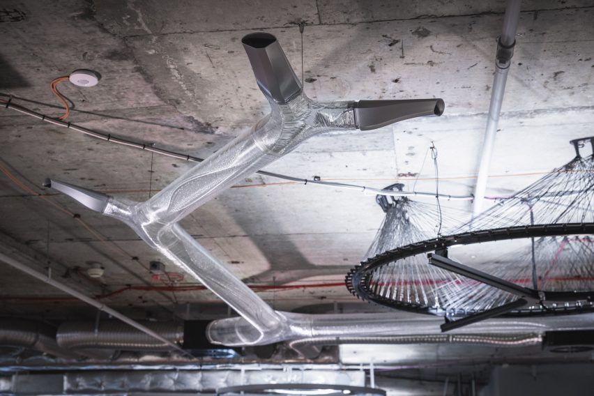 Photo of translucent plastic tubes branching underneath a concrete slab ceiling