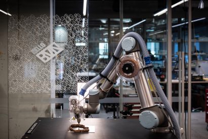 Photo of 3D-printing robot extruding material in coils