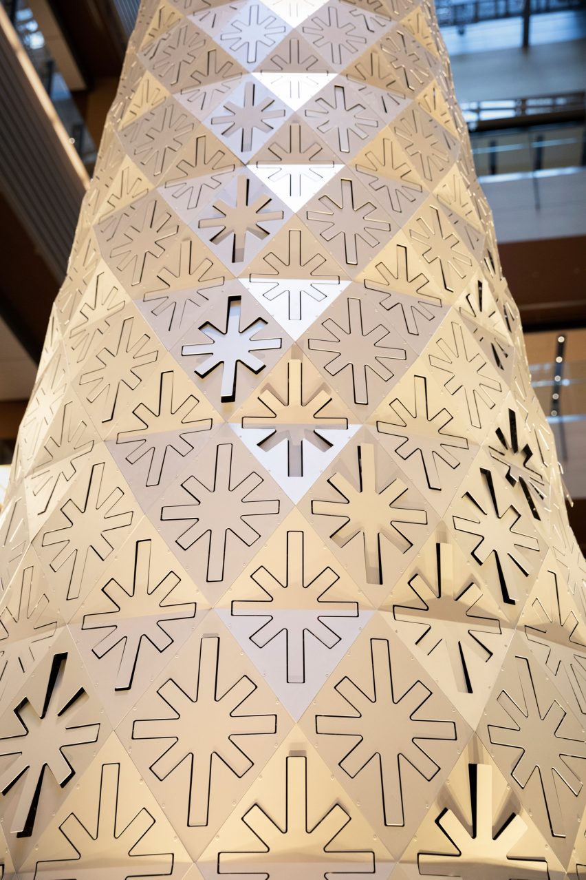Star-shaped cutouts on Christmas tree by Nendo