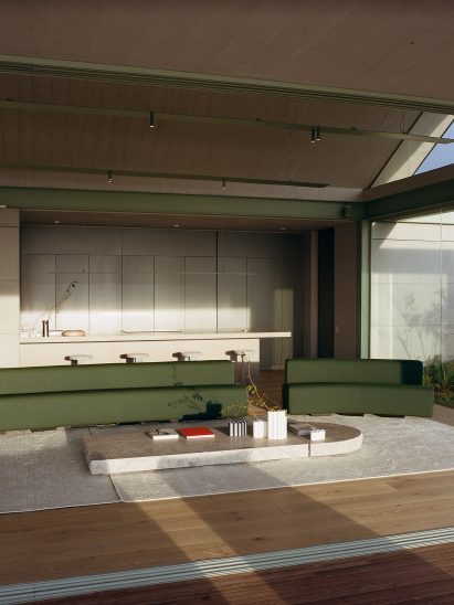 Green couches with minimal coffee table in J Balvin living room