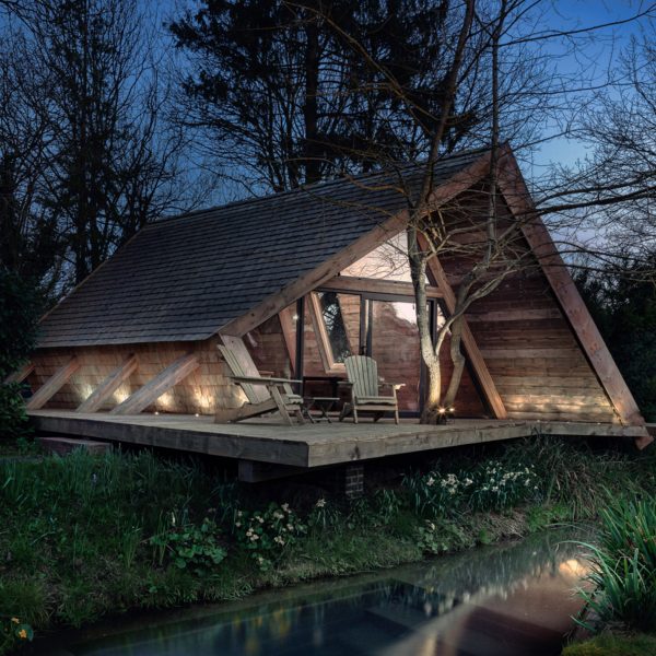 Exterior image of Climbers Cabin lit up at night