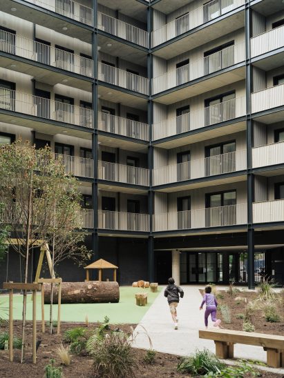 Children playing in courtyard of Dockley Apartments in London